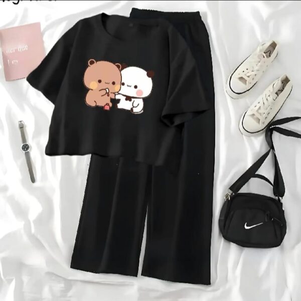 "Melt into the viral cuteness and supreme comfort of the 'Mocha & Milk' Set. Featuring an adorable cartoon graphic on a chic, cropped tee and paired with relaxed, high-waisted wide-leg trousers. This all-black ensemble is your new go-to for instant joy, effortless style, and maximum all-day comfort. Just slip on your sneakers and go—your look is complete."